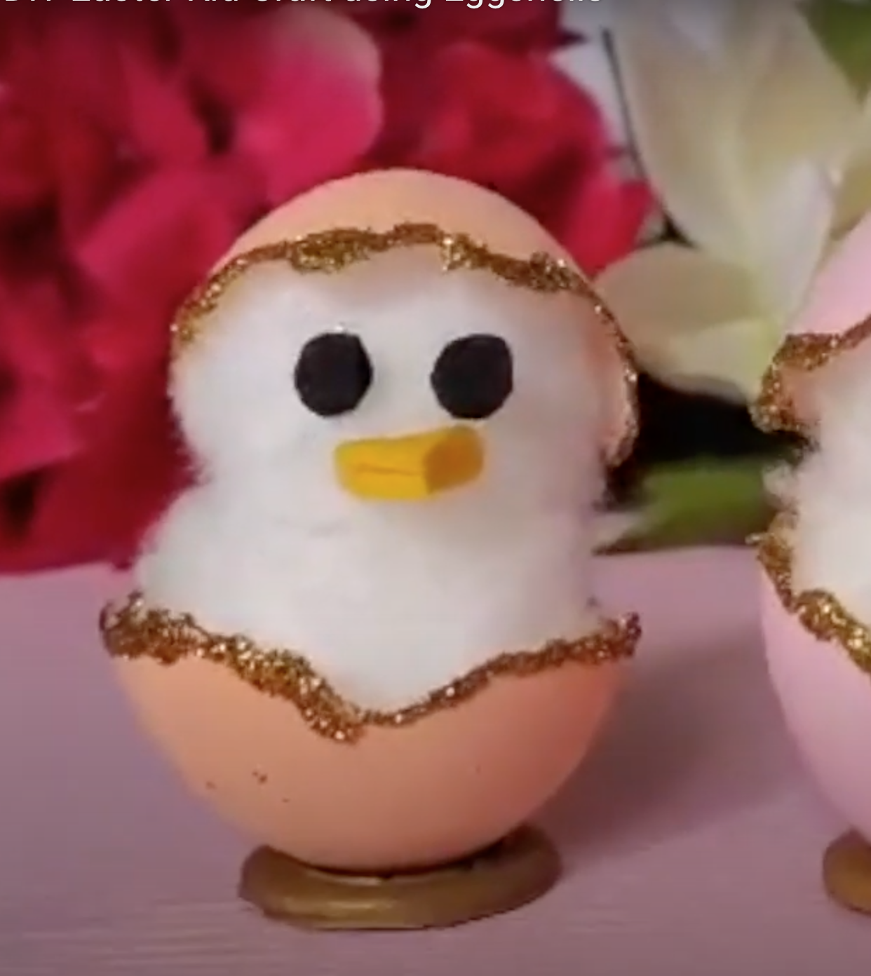 a hand made craft of a little chicken made out of cotton ball and egg shell